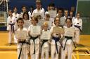 Students from the Mark Farnham Schools of Tae Kwon-Do celebrate their colour belt gradings at Ely