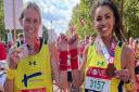 Kerry Bullen and Troi Baxter with their medals after setting a new Guinness World Record at the London Marathon.