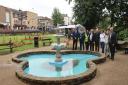 Fenland District Council’s Portfolio Holder for the Environment, Cllr Peter Murphy (fourth from the left), officially switches-on the new fountain in St Peter’s Church gardens during Wisbech Rose Fair. He is pictured with, from left, ISS Contract Mana