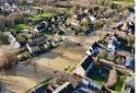 Anglian Water has been ordered to repay ?8.5m to its customers by the regulator Ofwat. Pictured: a neighbourhood flooded in Huntingdonshire.