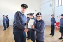 Group Captain David Boreham presents certificates at the Neale Wade Academy.