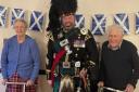Bagpiper Roy Solane (centre) with residents of Swan House care home in Chatteris