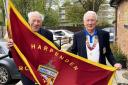 Harpenden president Angus Lowe hands the honour of raising the flag to Barrie Hills. Picture: HBC