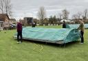 Stuart Arnold, Francis Gaimster, Nathan Oliver and Lewis Welcher putting the plastic sheets onto the covers.