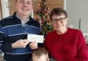 Chatteris Town Councillor James Carney and his son, Noel, handing the 'Poppy on a Lamppost' fundraiser cheque over to Poppy Appeal organiser Lynda Behagg.