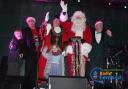 Santa and his helpers who switched on the town's lights