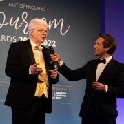 Alan Carr, winner of The East of England Tourism Awards 2021-2022's Outstanding Contribution to Tourism Award, on stage with host David Whiteley at last year's awards ceremony