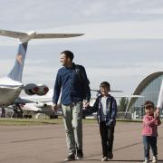 A family exploring IWM Duxford with the American Air Museum in the background. Picture: IWM