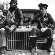 Captain Walker L. Boone, Flight Officer Manuel S. Martinez and Flight Officer Gerry E. Brasher, pilots of the American 78th Fighter Group, sit on the bonnet of a Dodge WC (weapons carrier) at Duxford air base, 1943. Picture: IWM FRE 282