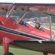Tom Cruise in a Boeing Stearman biplane at Duxford Airfield.