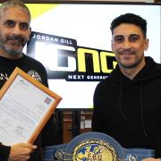 Jordan Gill with father Paul (left) and the European featherweight title won in February.