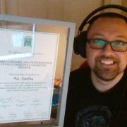 Phil Priestley, founder of the Cambs Youth Panel, with his Covid community champion award, signed by Cambridgeshire MPs including Lucy Frazer.