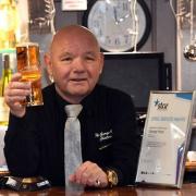 Robbie Lyons, licensee of The George Hotel in Chatteris, has died. He is pictured in December 2020, when he scooped a long service award to mark his 20th anniversary at the helm.