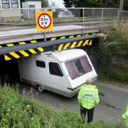 Stonea Road bridge near Manea has become well-know for bring struck. Pictured is a caravan that misjudged its height and got wedged under the bridge.