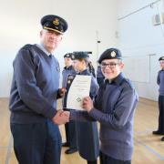Group Captain David Boreham presents certificates at the Neale Wade Academy.