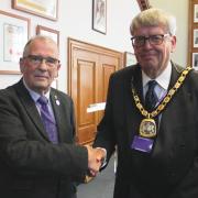 Outgoing Fenland District Council Chairman Cllr Alex Miscandlon, left, with incoming Chair Cllr Nick Meekins