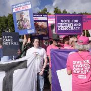 Campaigners during a protest for and against assisted dying outside Parliament (Stefan Rousseau/PA)