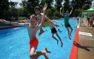 A group of friends leap into the Jesus Green Lido in Cambridge on Monday, July 18, when temperatures reached 36C