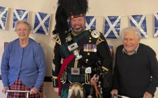 Bagpiper Roy Solane (centre) with residents of Swan House care home in Chatteris