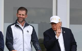 US President Donald Trump with his son Eric Trump (Damien Eagers/PA)